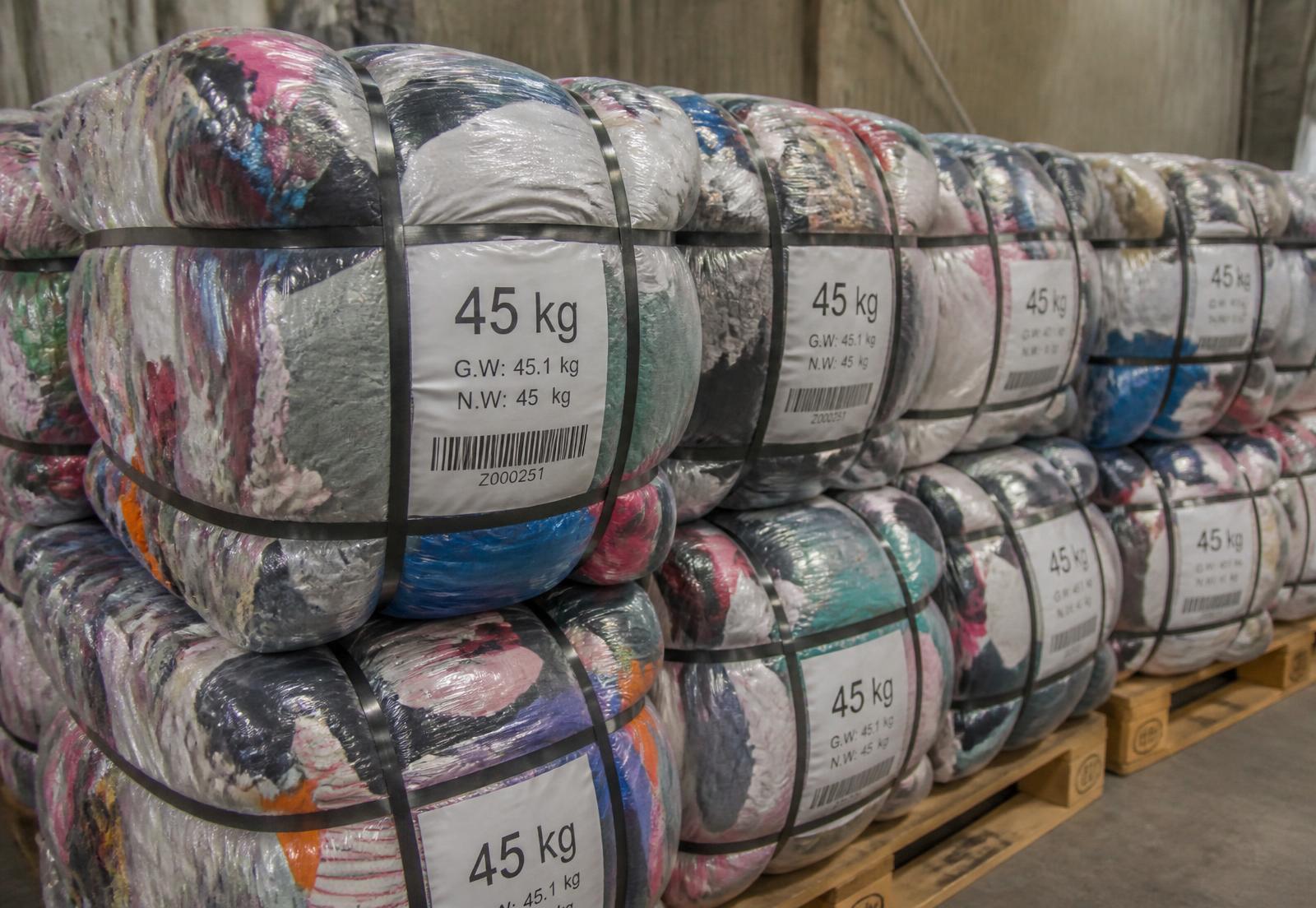 Compressed 45 kg used-clothing bales on pallets