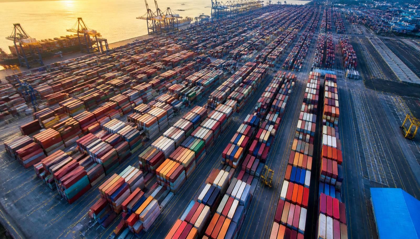 Aerial view of a container terminal with hundreds of stacked shipping containers